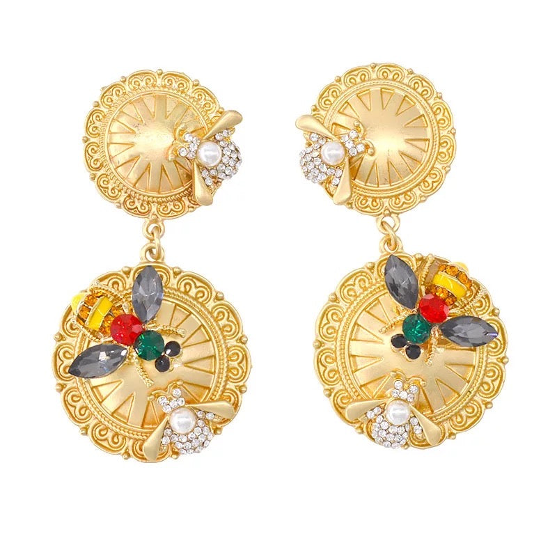 Gold round earrings with bee design. 